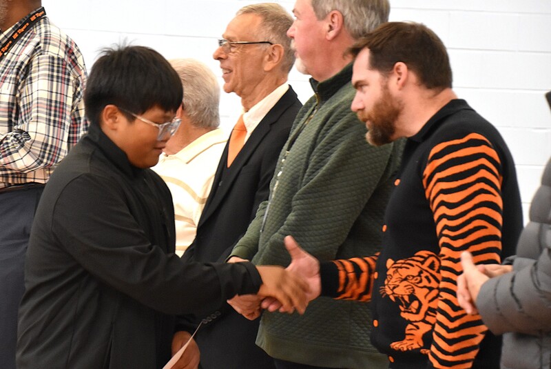JFS student shaking hands with board member.