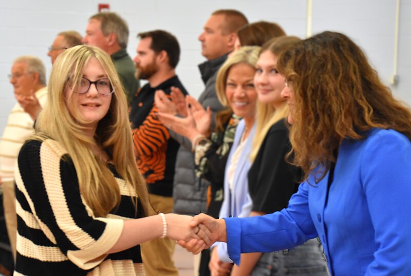 JFS student shaking hands with board member.