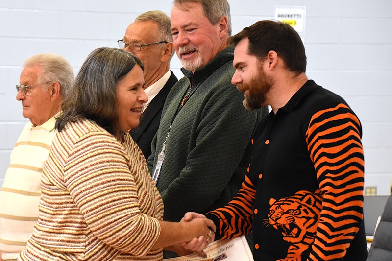 JFS staff member shaking hands with board member.