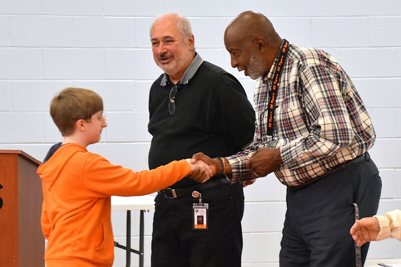 JFS student shaking hands with board member.