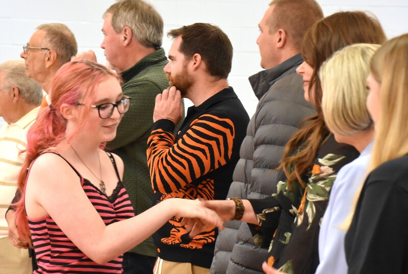 JFS student shaking hands with board member.