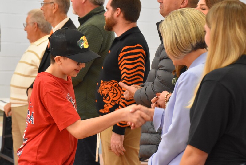 JFS student shaking hands with board member.