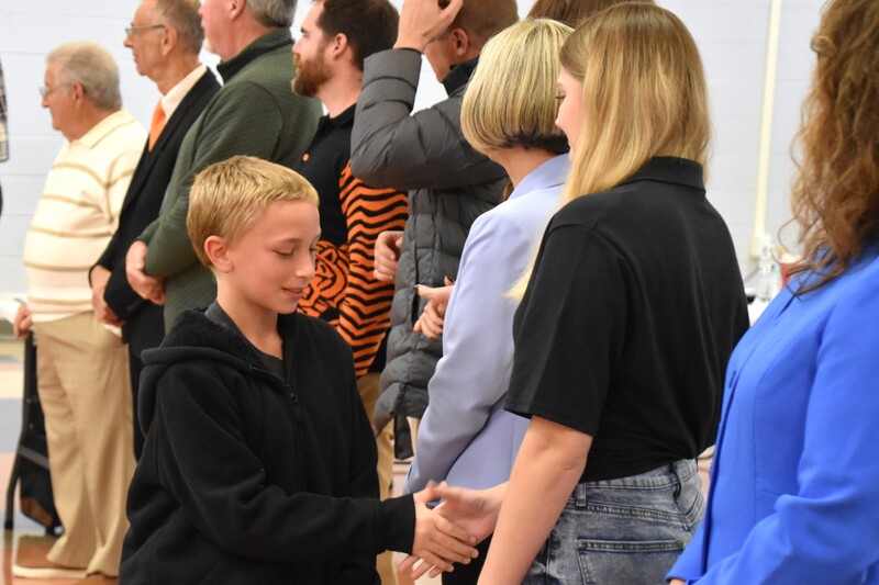 JFS student shaking hands with board member.