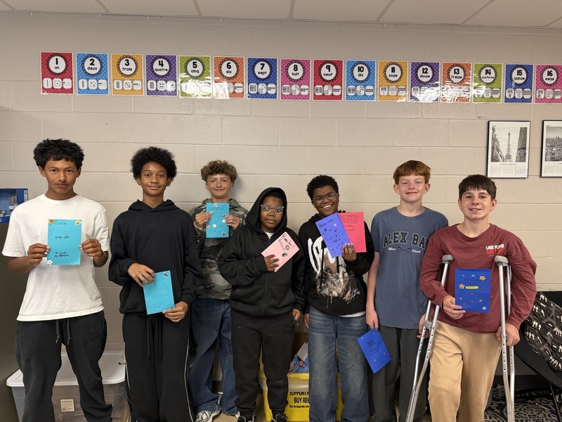U-E middle school students holding encouragement cards