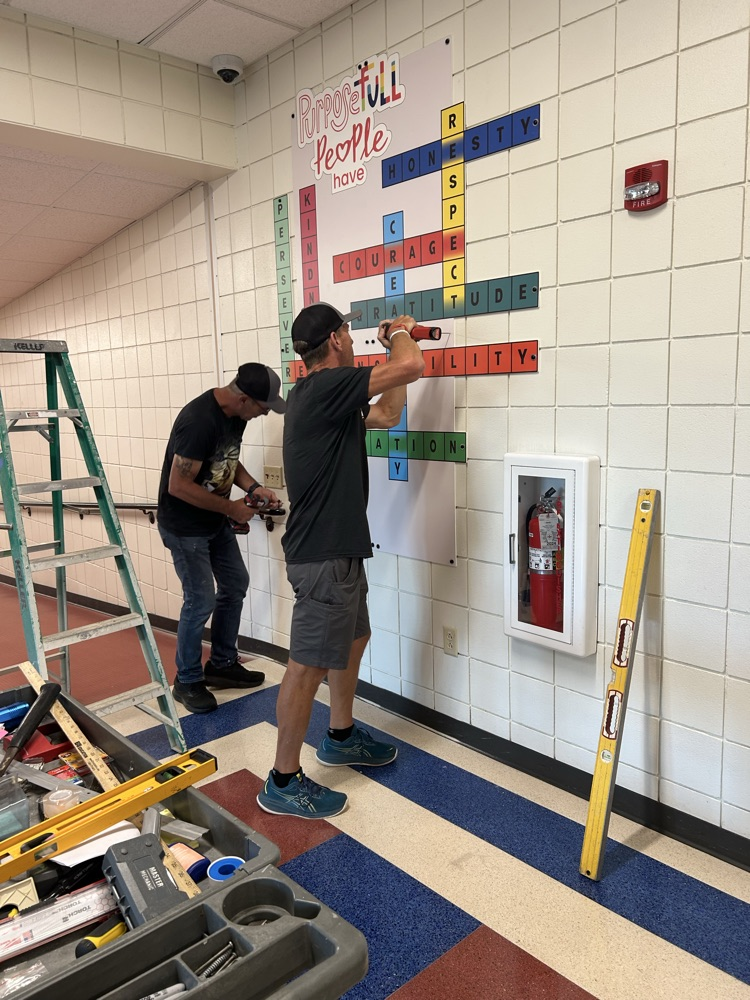 custodians installing artwork