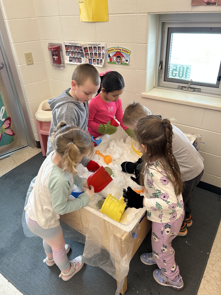 students playing with snow in a water table