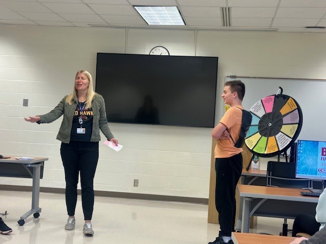 student and adult with prize wheel