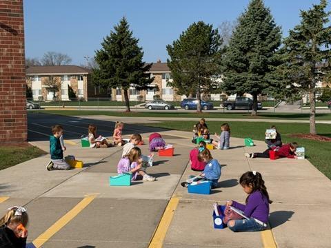 kindergarten student reading outside