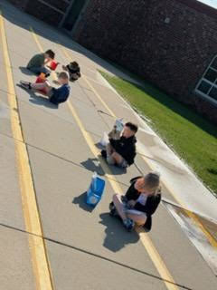 kindergarten student reading outside