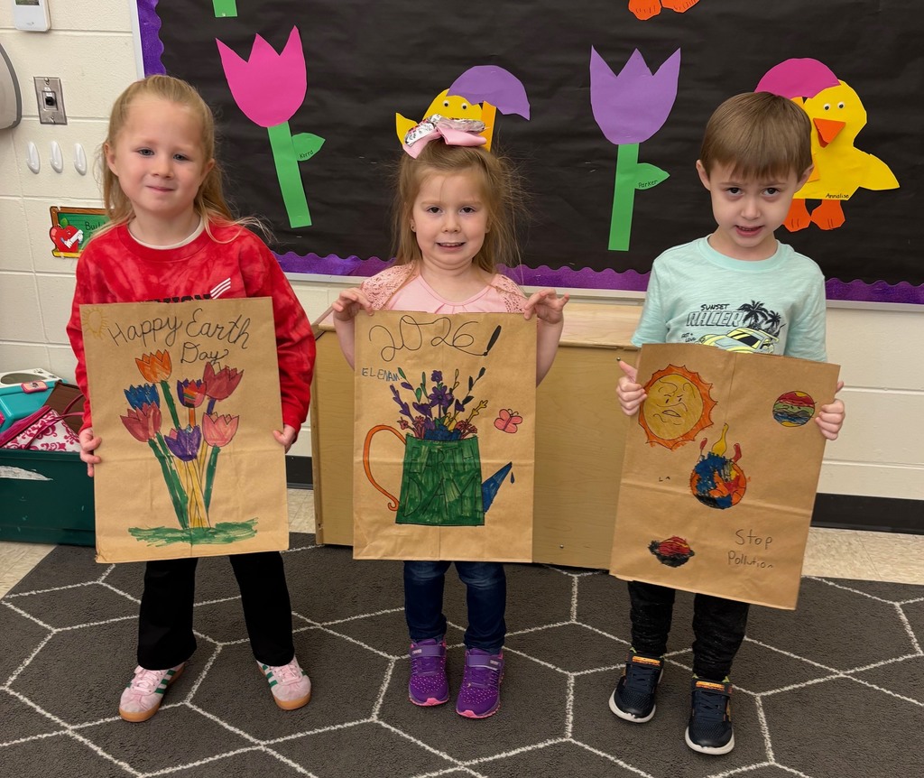 students hold their decorated paper grocery bags
