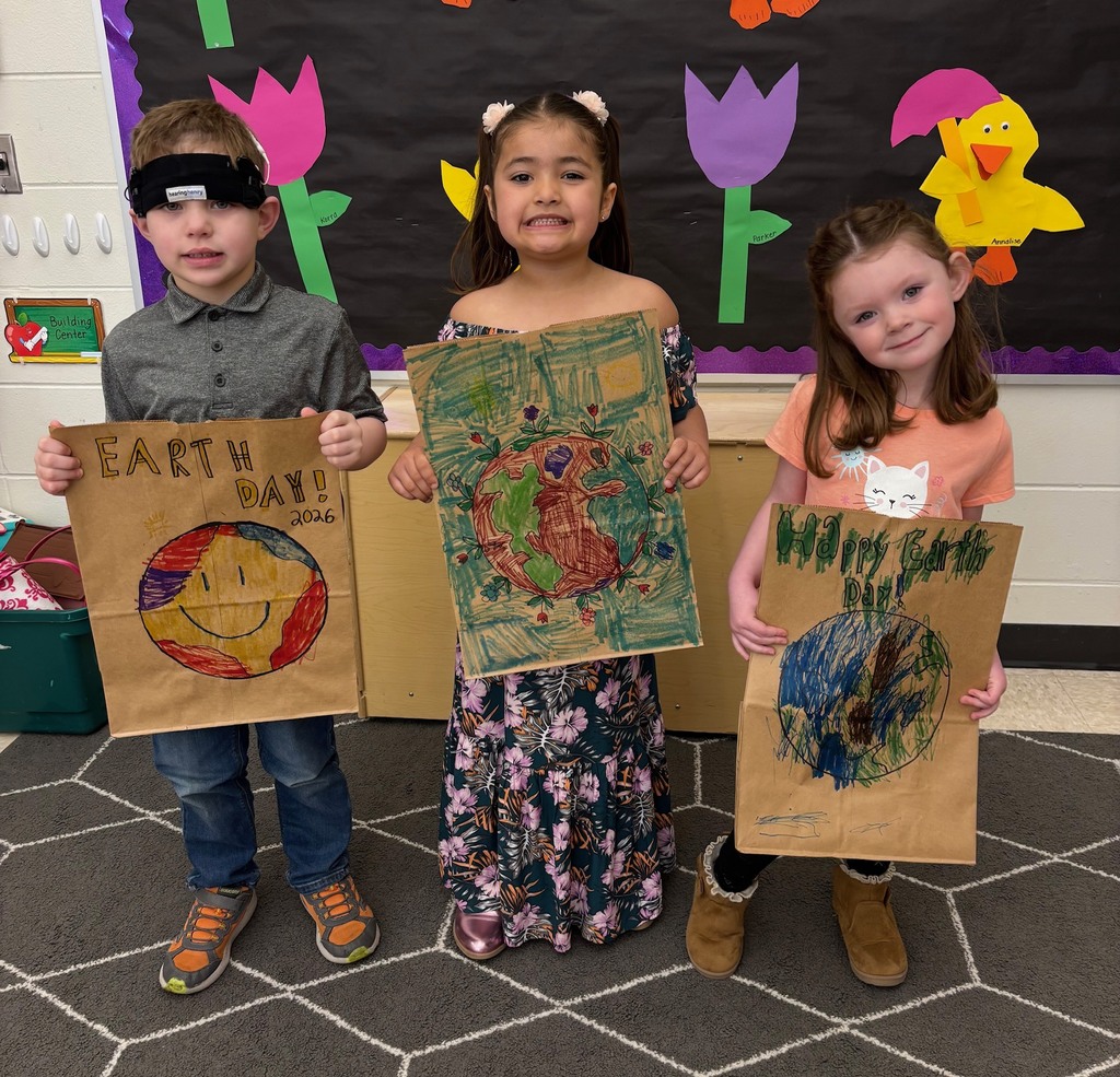 students hold their decorated paper grocery bags