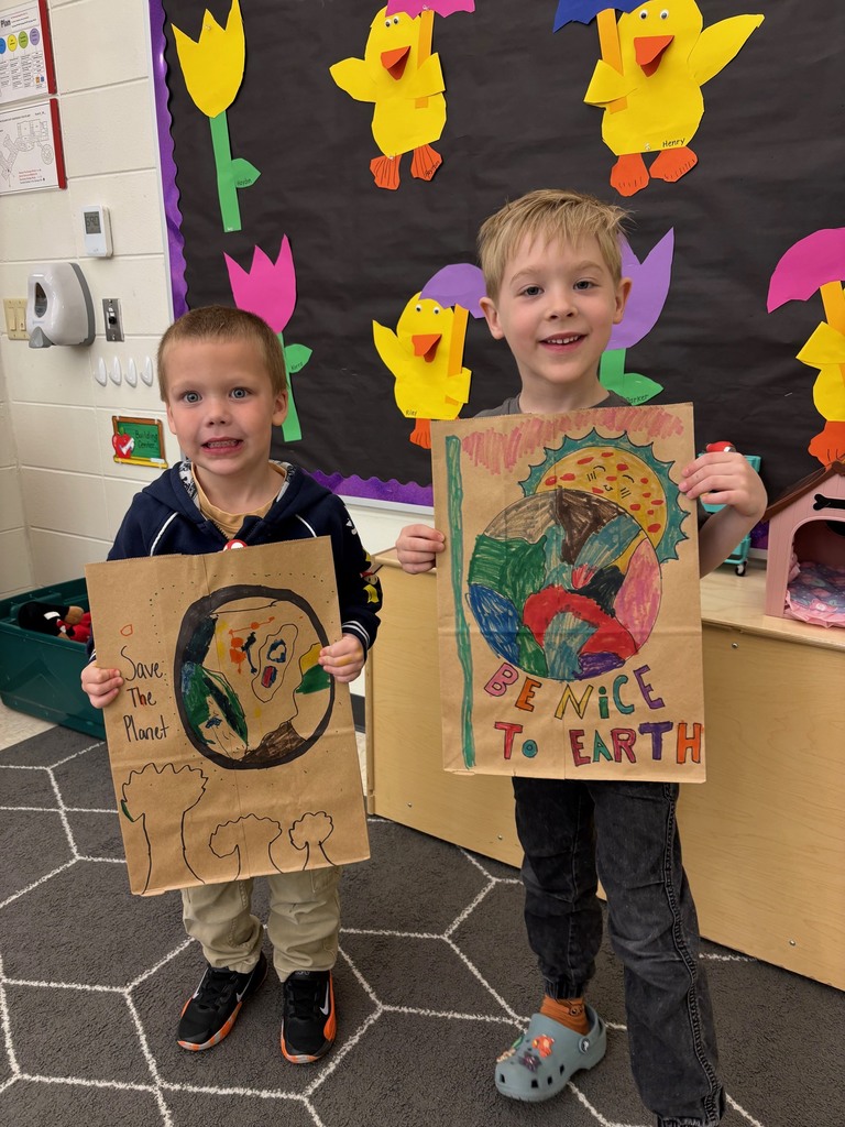 students hold their decorated paper grocery bags