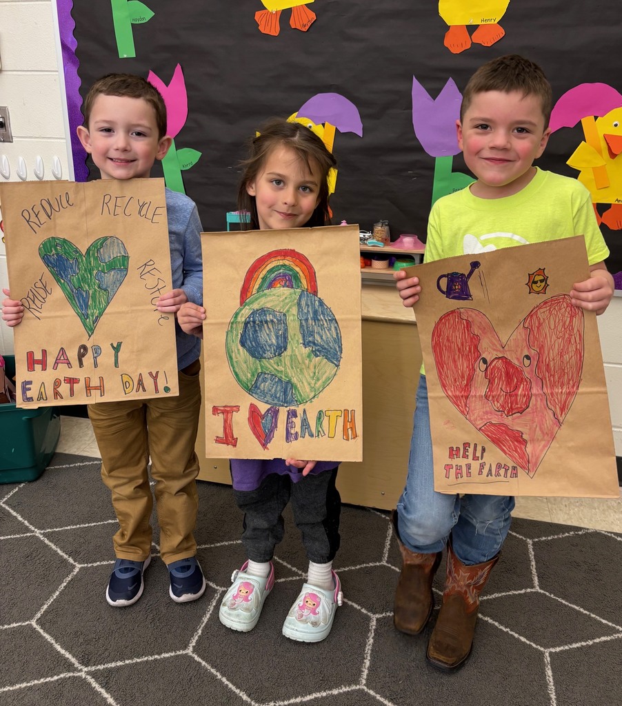 students hold their decorated paper grocery bags