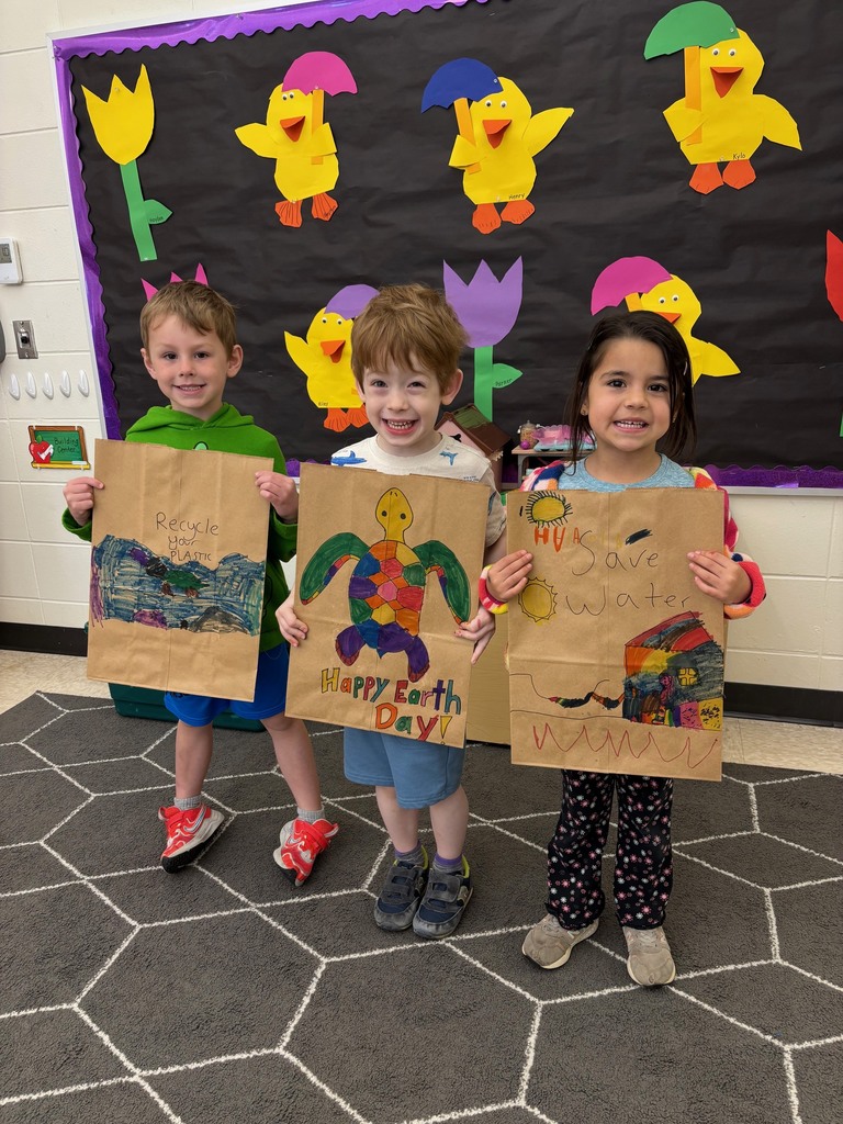 students hold their decorated paper grocery bags