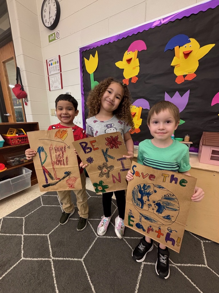 students hold their decorated paper grocery bags