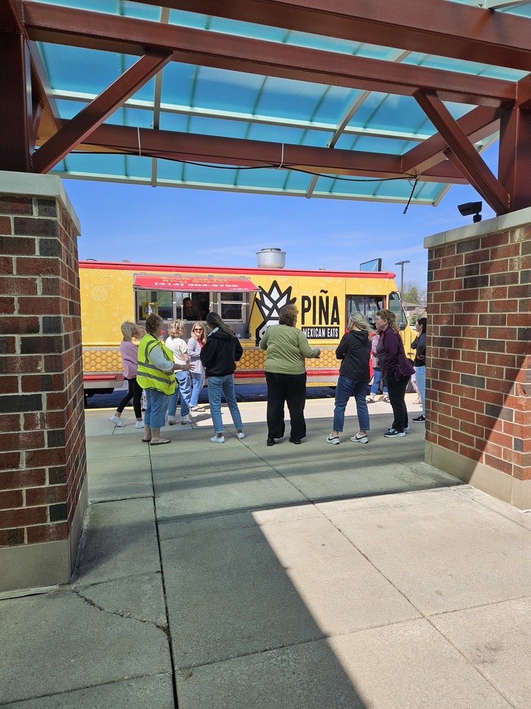 staff order food at a food truck and enjoy the weather