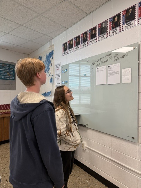 students looking at veteran's letters