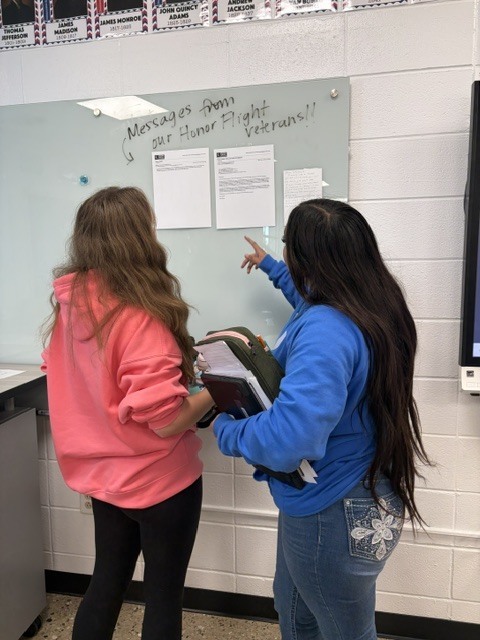 students looking at veteran's letters