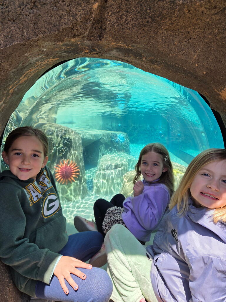 students smiling for the camera at an underwater exhibit