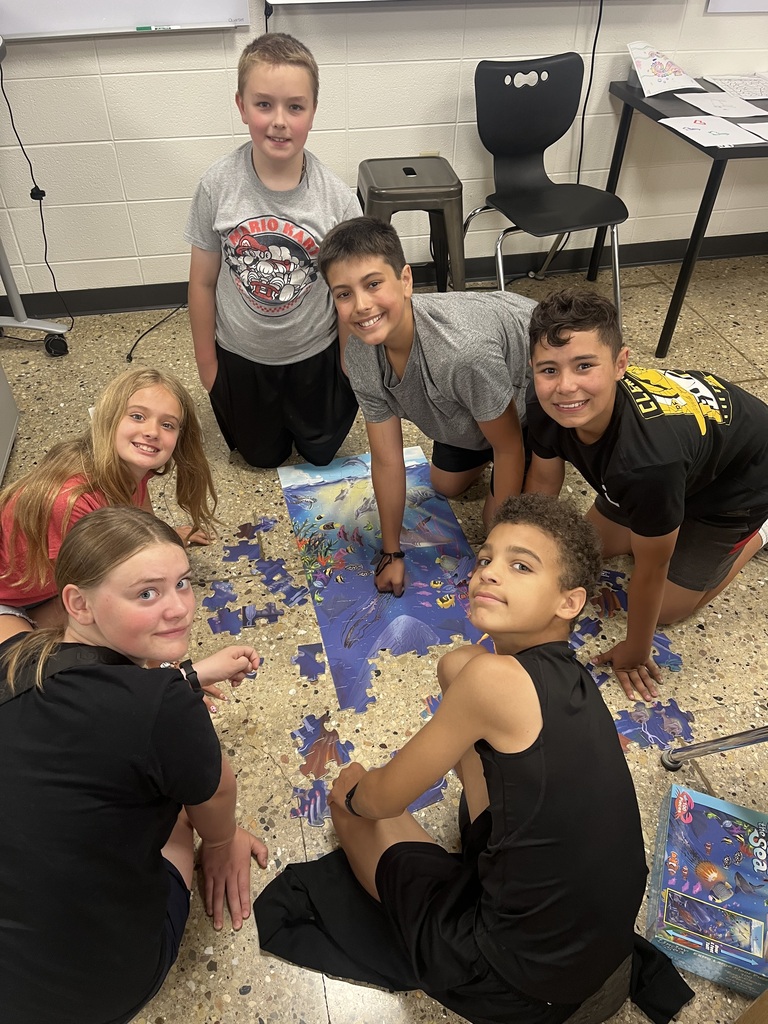 students work together on a floor puzzle