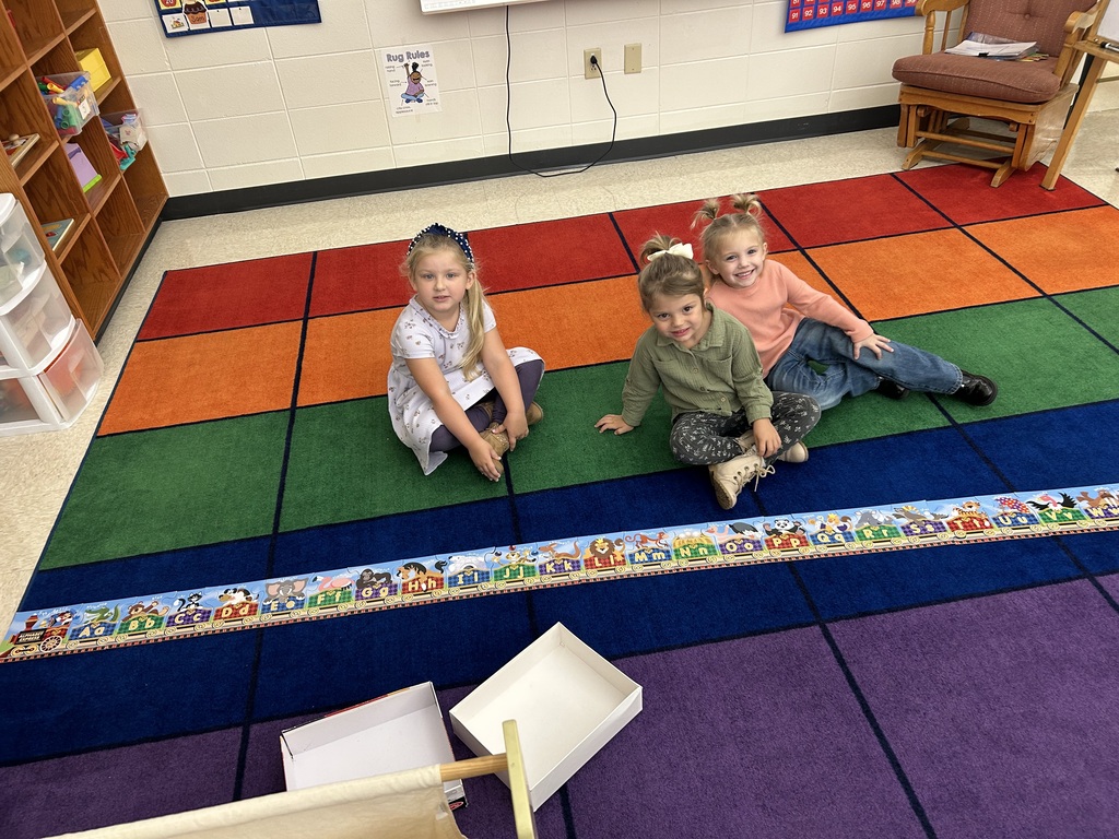 4K students pose for a photo with their completed puzzle