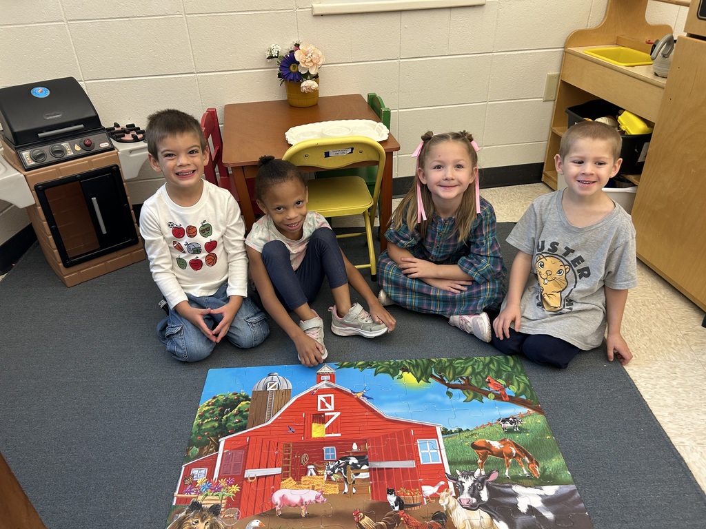 4K students pose for a photo with their completed puzzle