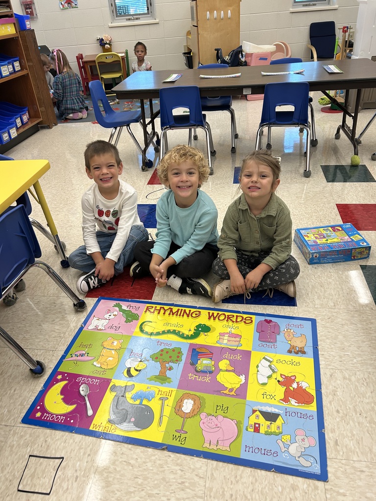 4K students pose for a photo with their completed puzzle