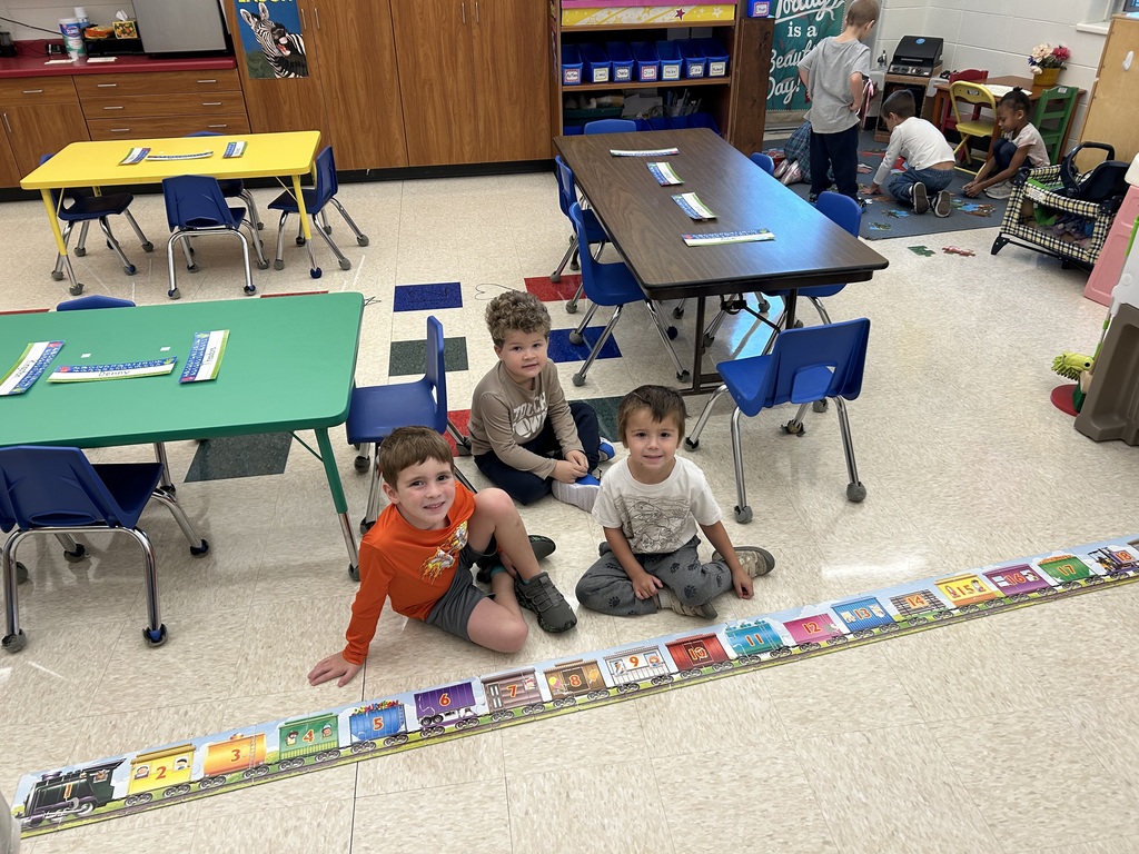 4K students pose for a photo with their completed puzzle