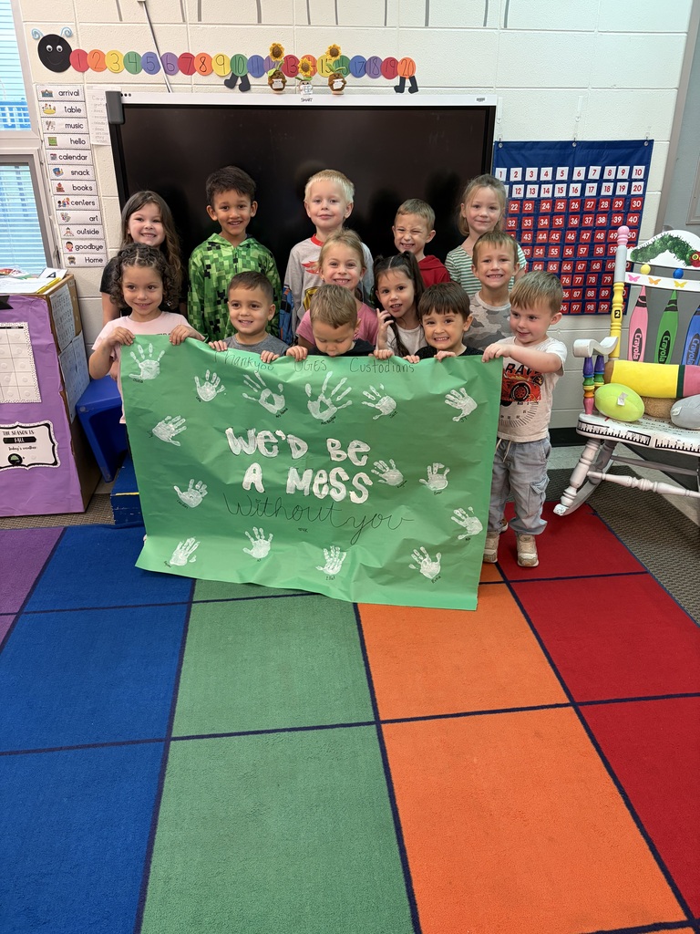 4K students pose with a banner they made that says "We'd be a mess without you"
