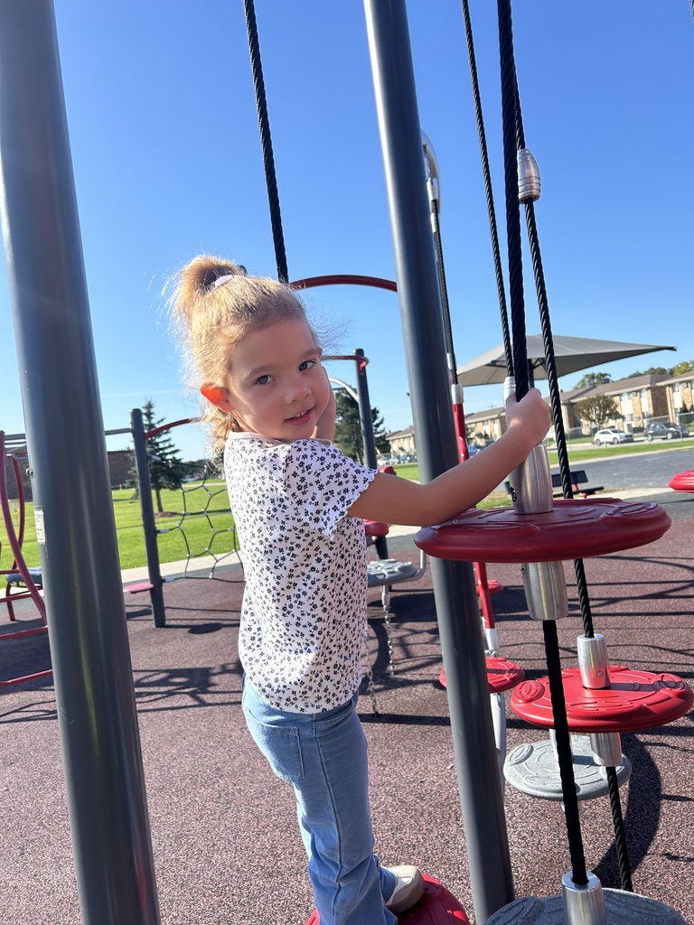 a 4k student uses playground equipment