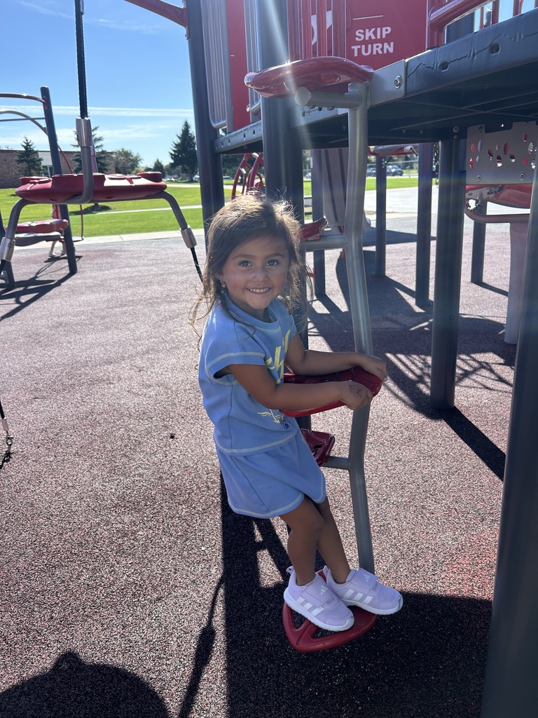 a 4k student uses playground equipment