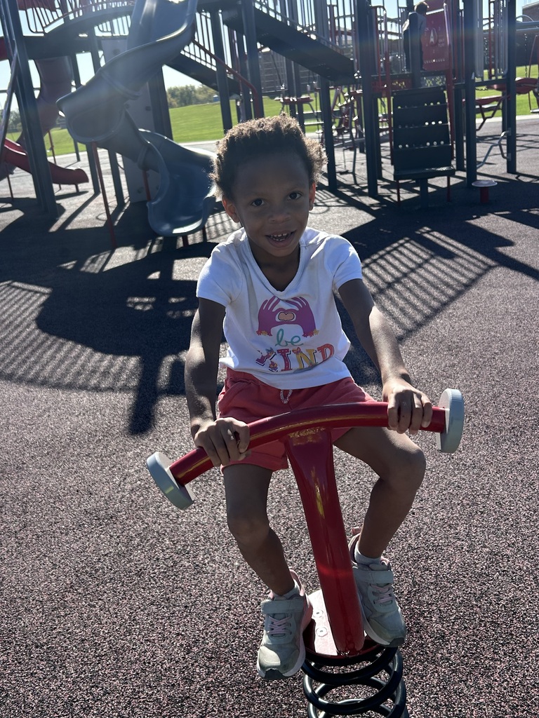 a 4k student uses playground equipment
