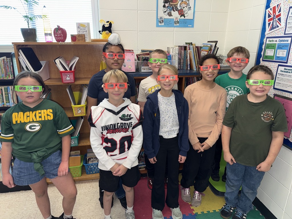 students pose with their glasses on