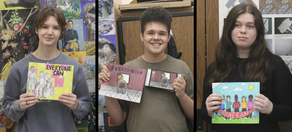 Students holding their award winning artwork.