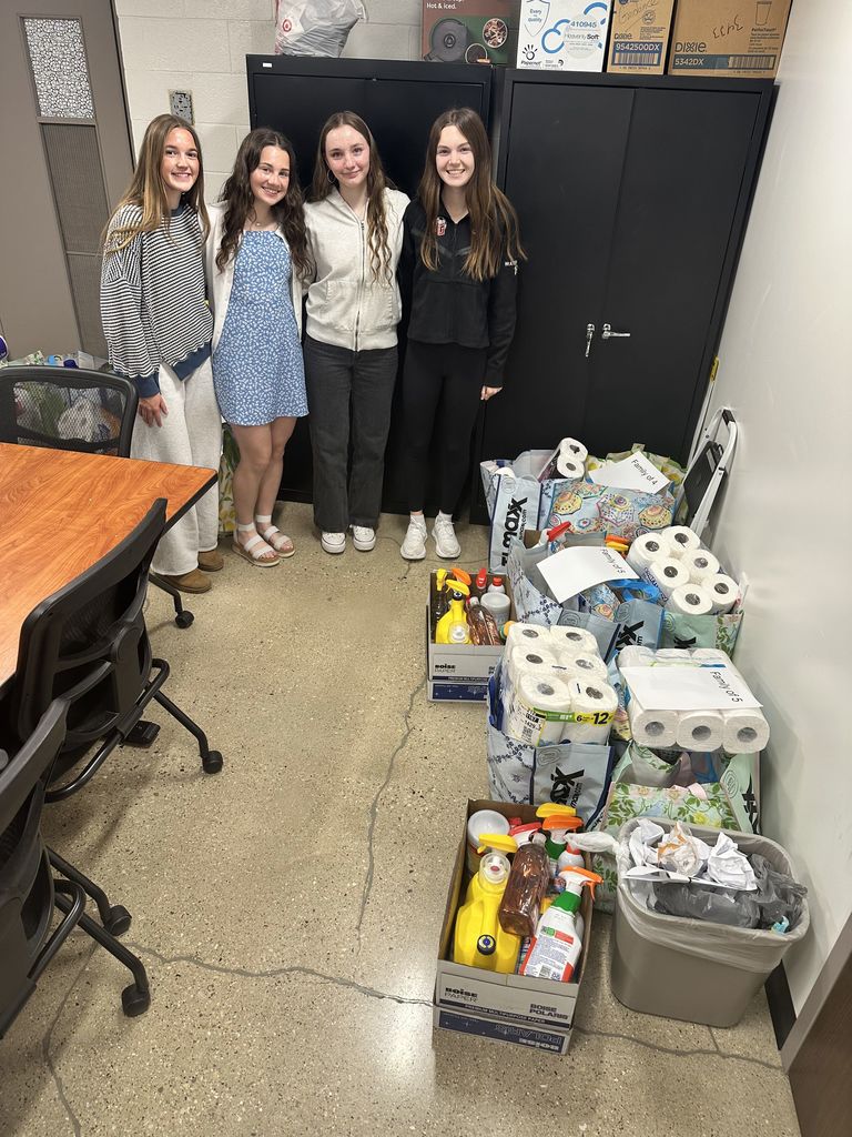 Students standing with boxes with donated items.