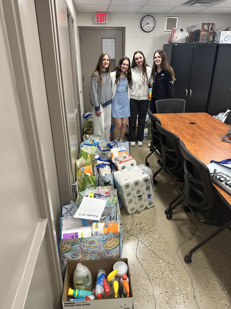 Students standing with boxes with donated items.