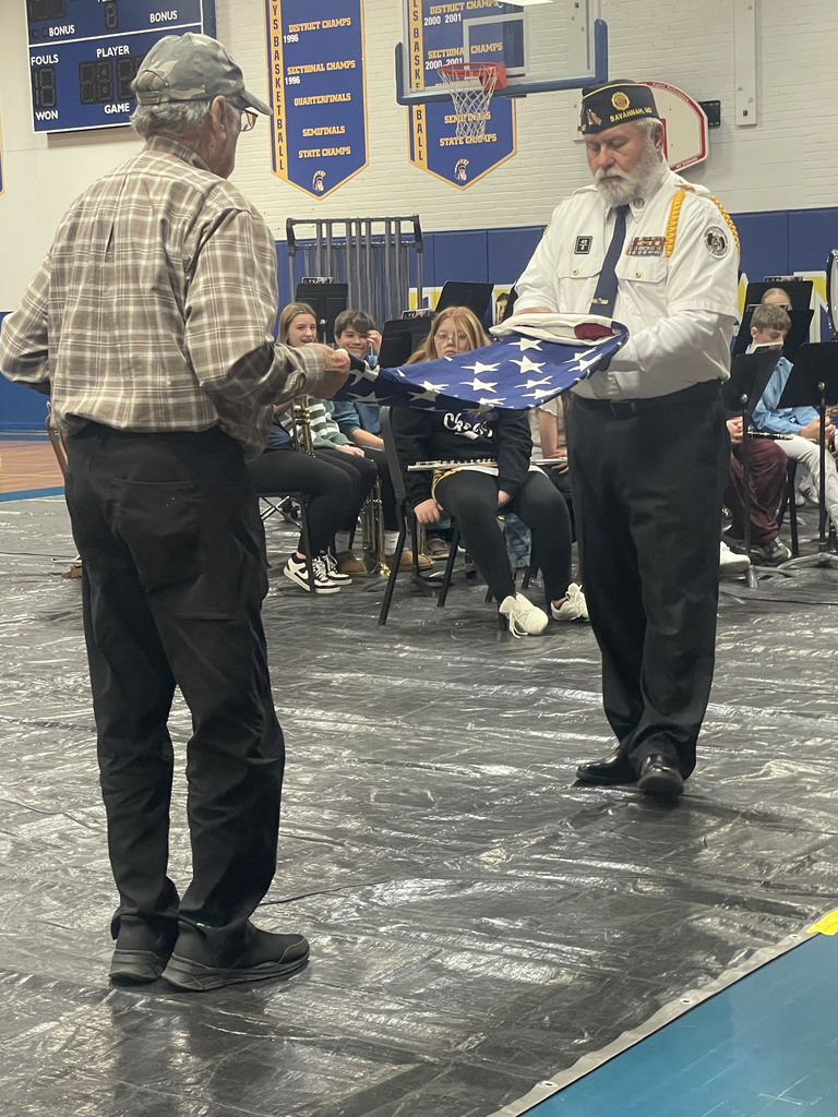 American Legion Post #287 members perform the Flag Folder Ceremony. One holds the flag while the other makes triangular folds.