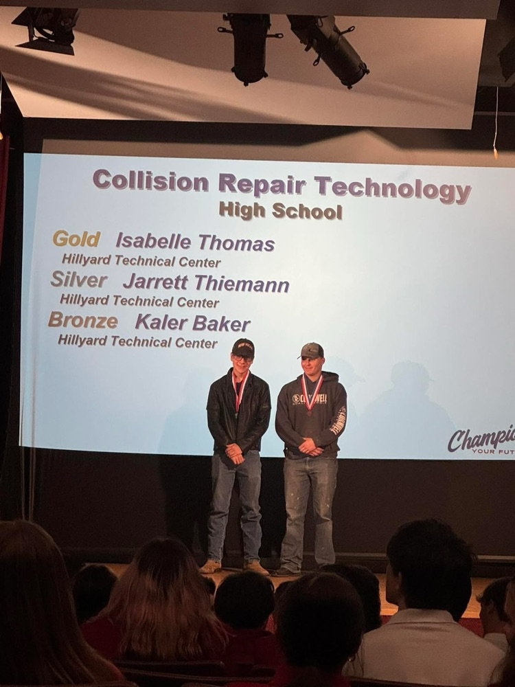 Two high school vocational technical students show their awards.