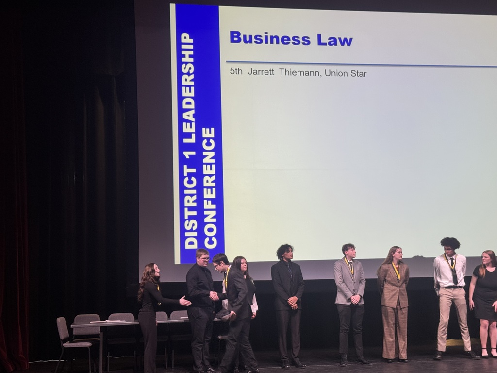 Jarrett Thiemann and other FBLA students stand on stage during the awards ceremony.