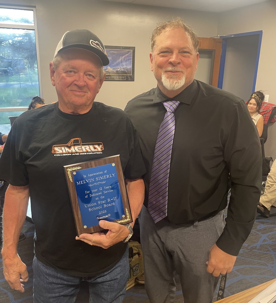 Outgoing board of education president Mel Simerly holds a plaque he has received from Superintendent Rick Calloway, also pictured, for 12 years of service to the board.