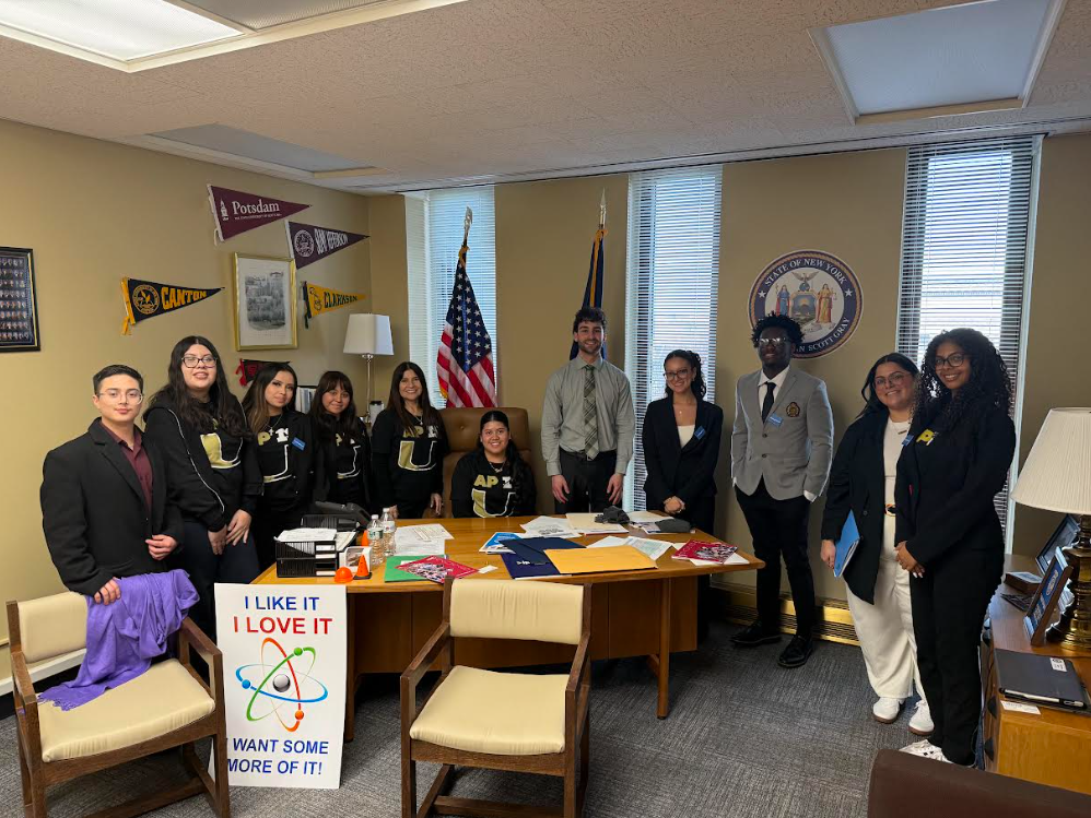 students group picture by desk