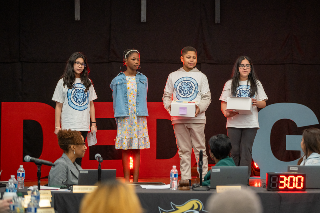 Students giving a talk on stage