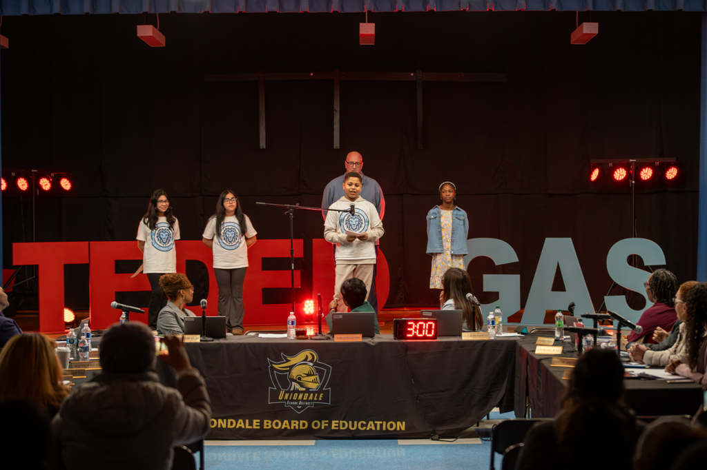 Students giving a talk on stage