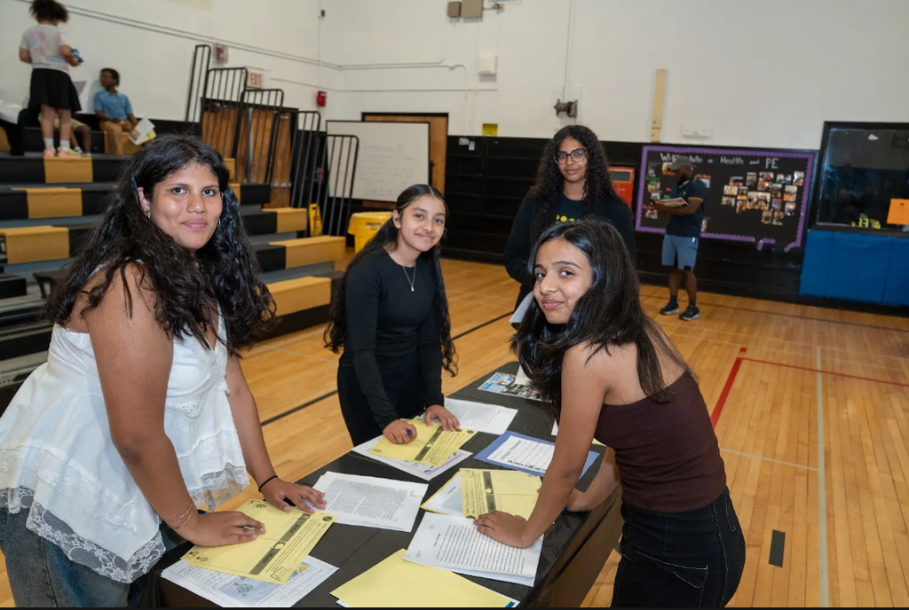 Students at a table with papers