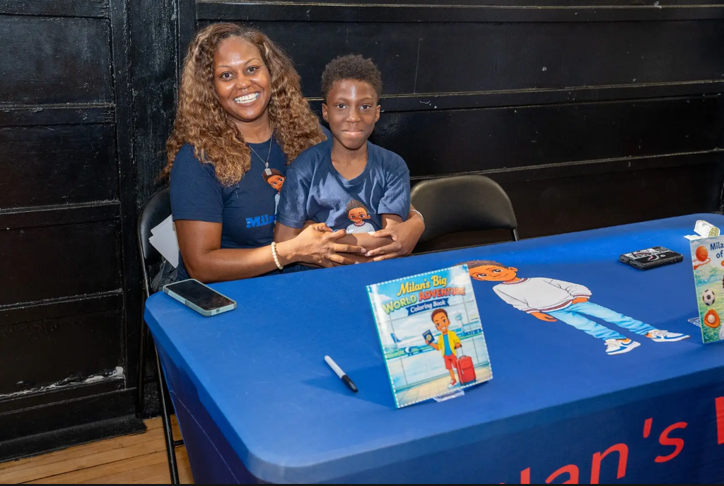 Two people with book at a table