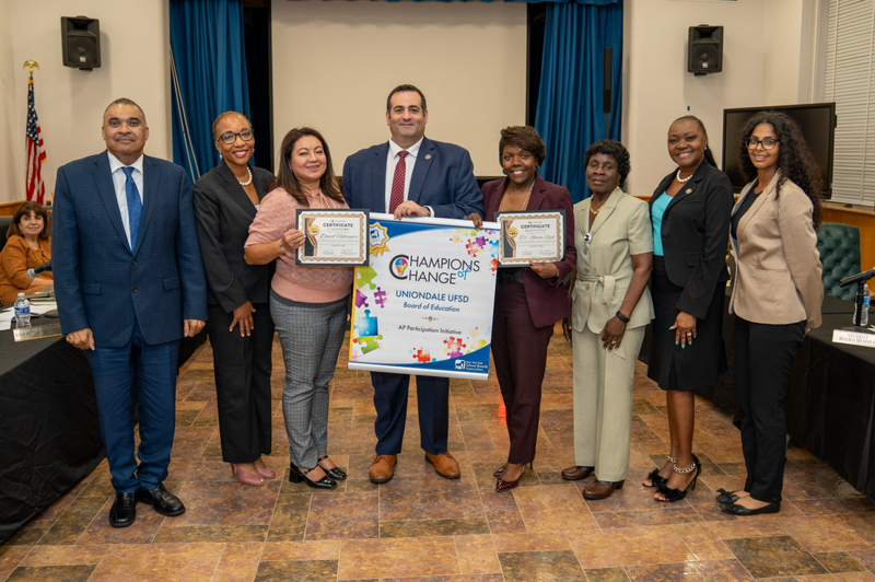 school members holding an award 