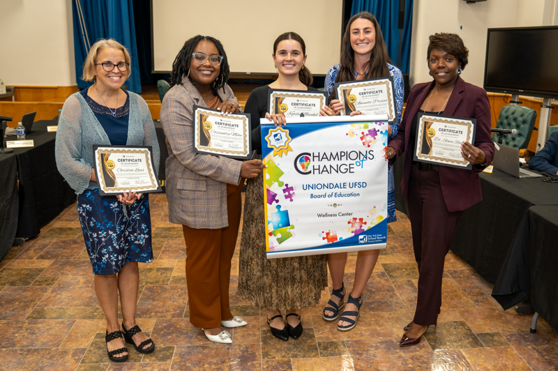 School members holding an award