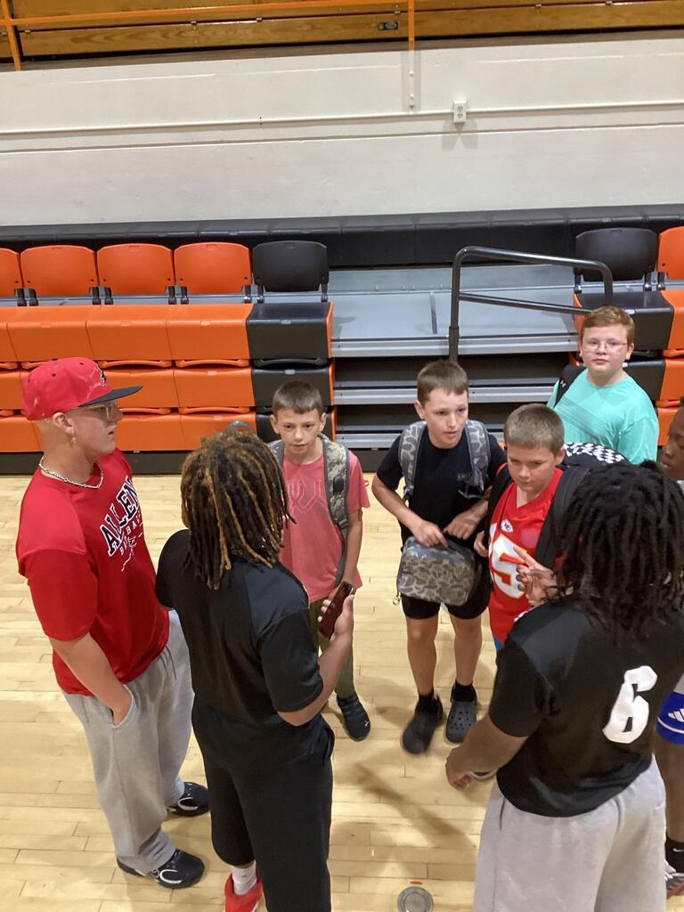 ACC athlete giving a pep talk to WBE students before class.