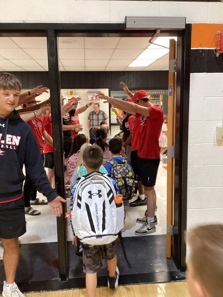 ACC athletes creating a tunnel for a WBE student.