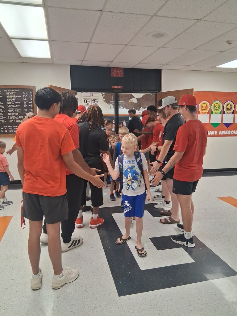ACC athletes giving high 5's as WBE students head to class.